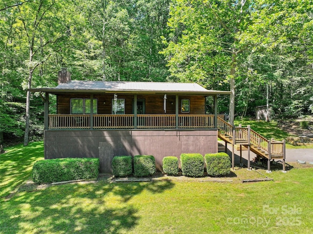 250 Turkey Pen Rd, Franklin, NC 28734 - rustic home with a porch, a chimney, a front yard, stairway, and a wooded view