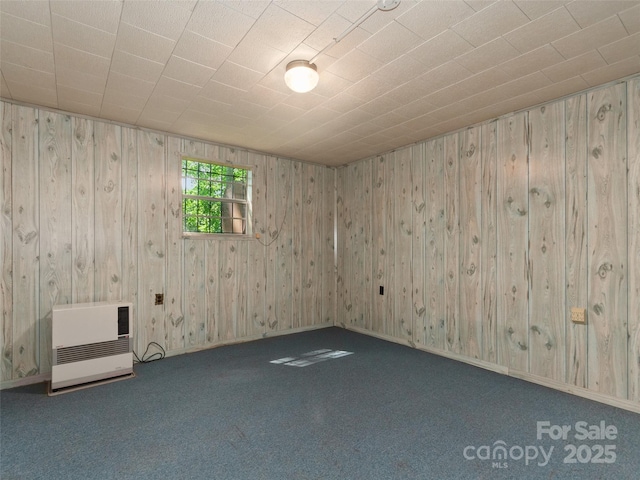 250 Turkey Pen Rd, Franklin, NC 28734 - unfurnished room featuring heating unit, wood walls, and carpet flooring