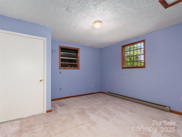 250 Turkey Pen Rd, Franklin, NC 28734 - spare room featuring a baseboard radiator, carpet floors, and a textured ceiling