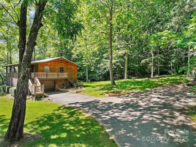 250 Turkey Pen Rd, Franklin, NC 28734 - chalet / cabin with asphalt driveway, an attached garage, stairs, a front yard, and a deck