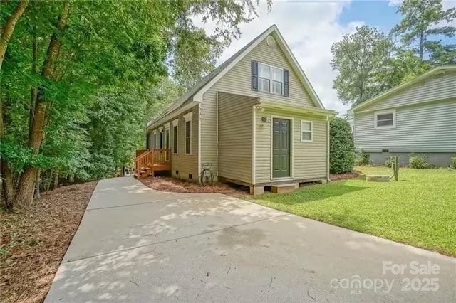 696 Springwood Dr, Mount Gilead, NC 27306 - rear view of house featuring a lawn