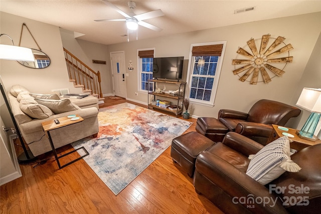 696 Springwood Dr, Mount Gilead, NC 27306 - living room featuring stairs, wood finished floors, and ceiling fan