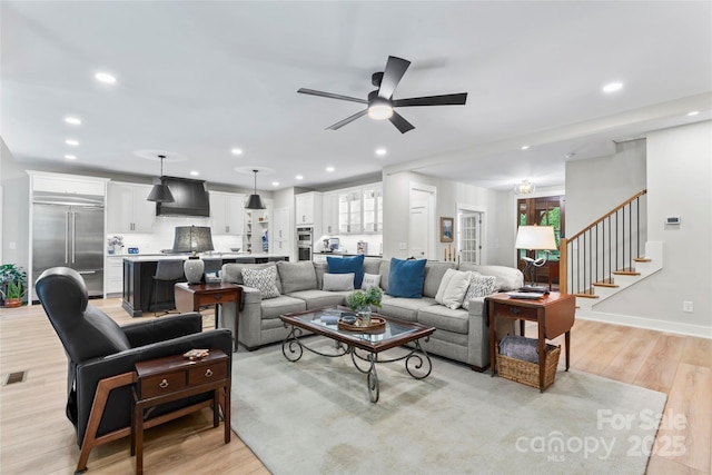 2866 Backwoods Trl, Denver, NC 28037 - living area featuring light wood finished floors, a ceiling fan, recessed lighting, and stairway