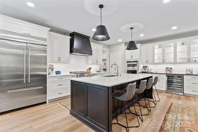 2866 Backwoods Trl, Denver, NC 28037 - kitchen featuring appliances with stainless steel finishes, wine cooler, premium range hood, backsplash, and recessed lighting