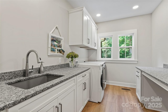 2866 Backwoods Trl, Denver, NC 28037 - washroom with cabinet space, light wood-style flooring, recessed lighting, and independent washer and dryer