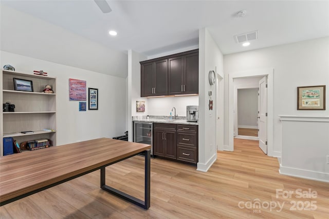 2866 Backwoods Trl, Denver, NC 28037 - kitchen with wine cooler, dark brown cabinetry, light wood-type flooring, recessed lighting, and ceiling fan