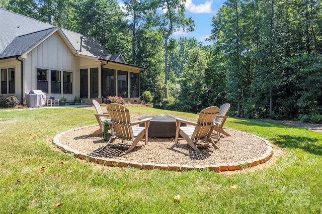 2866 Backwoods Trl, Denver, NC 28037 - view of green lawn with a sunroom, a fire pit, and a patio area