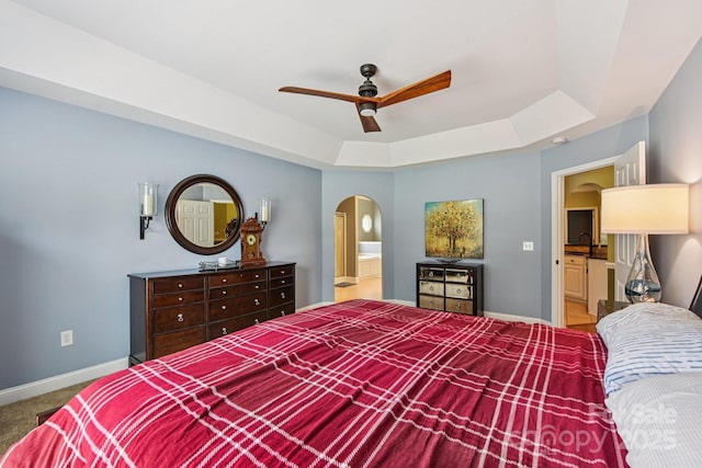 3865 Willow Grove Ln, Concord, NC 28025 - bedroom with arched walkways, a tray ceiling, carpet floors, ensuite bath, and a ceiling fan