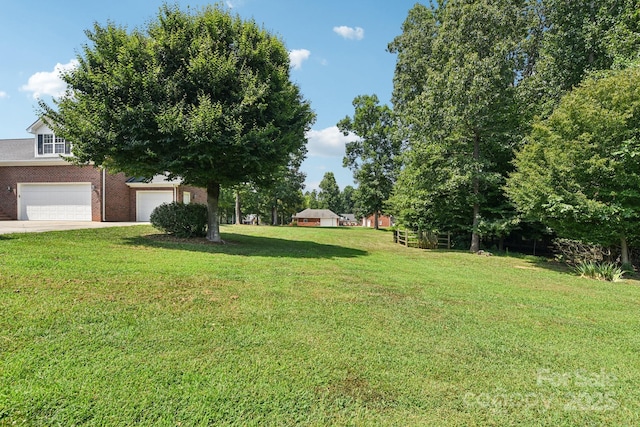 3865 Willow Grove Ln, Concord, NC 28025 - view of green lawn with a garage and driveway