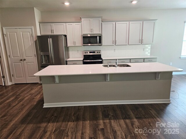 368 Saddlebred Ln, Locust, NC 28097 - kitchen with appliances with stainless steel finishes, light countertops, decorative backsplash, a kitchen island with sink, and recessed lighting