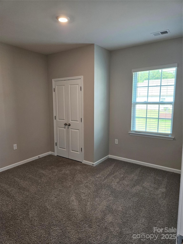 368 Saddlebred Ln, Locust, NC 28097 - unfurnished bedroom featuring dark colored carpet and a closet