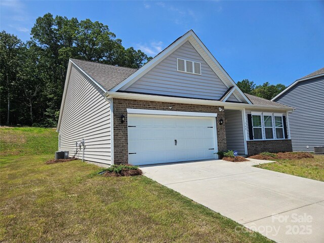 368 Saddlebred Ln, Locust, NC 28097 - view of front of house with brick siding, an attached garage, a front yard, driveway, and roof with shingles