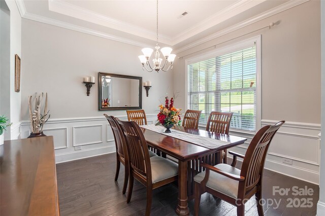 461 Swift Creek Cv, Clover, SC 29710 - dining room with dark wood finished floors, a chandelier, a decorative wall, ornamental molding, and a wainscoted wall