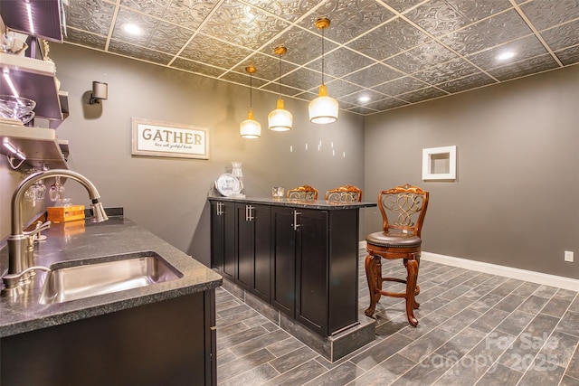 461 Swift Creek Cv, Clover, SC 29710 - indoor wet bar featuring an ornate ceiling, dark wood-style floors, recessed lighting, and pendant lighting