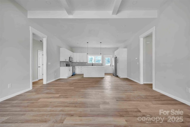 2325 32nd St NE, Hickory, NC 28601 - unfurnished living room featuring beamed ceiling and light wood-type flooring