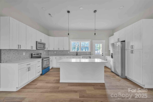 2325 32nd St NE, Hickory, NC 28601 - kitchen featuring appliances with stainless steel finishes, light countertops, a kitchen island, white cabinetry, and recessed lighting