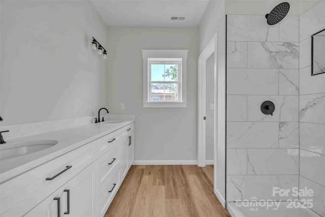 2325 32nd St NE, Hickory, NC 28601 - bathroom featuring a tile shower, wood finished floors, and double vanity