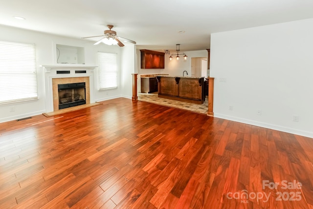 414 Bob Hardin Rd, Rutherfordton, NC 28139 - unfurnished living room with a ceiling fan, dark wood-style floors, a tiled fireplace, and recessed lighting