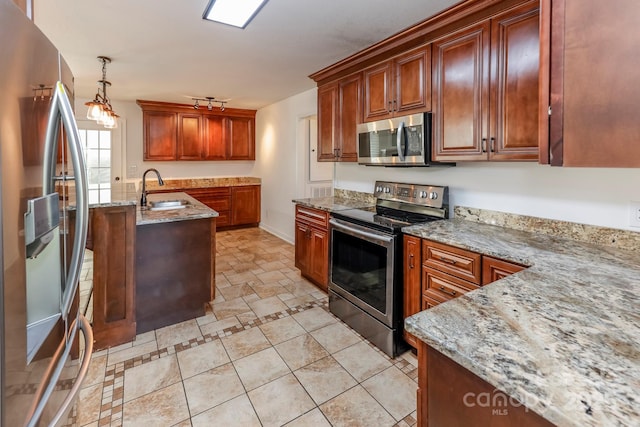 414 Bob Hardin Rd, Rutherfordton, NC 28139 - kitchen with stainless steel appliances, light stone countertops, pendant lighting, and a kitchen island with sink