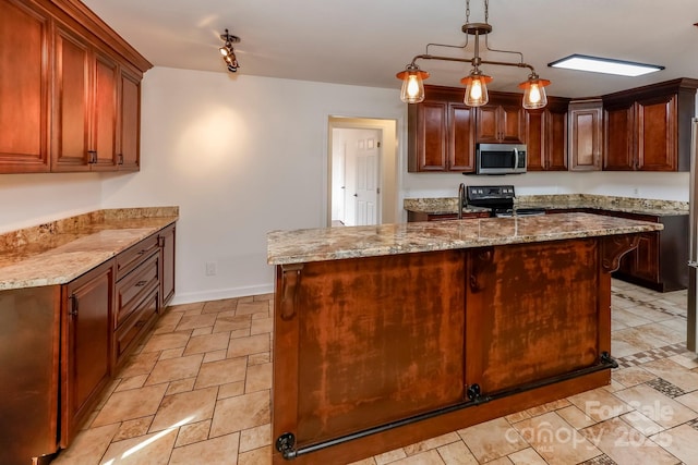 414 Bob Hardin Rd, Rutherfordton, NC 28139 - kitchen with stainless steel microwave, electric range oven, light stone counters, a kitchen island with sink, and pendant lighting