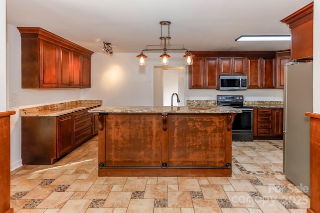 414 Bob Hardin Rd, Rutherfordton, NC 28139 - kitchen featuring appliances with stainless steel finishes, light stone counters, a kitchen island with sink, hanging light fixtures, and light stone finish flooring
