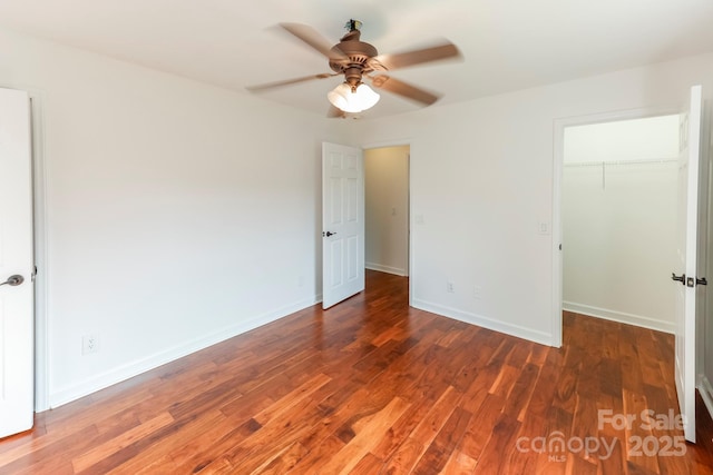 414 Bob Hardin Rd, Rutherfordton, NC 28139 - unfurnished bedroom with wood finished floors, a spacious closet, and ceiling fan