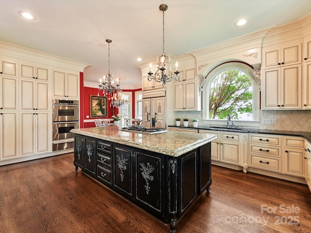 18201 Mainsail Pointe Dr, Cornelius, NC 28031 - kitchen with cream cabinetry, dark cabinetry, a chandelier, a warming drawer, and stainless steel appliances