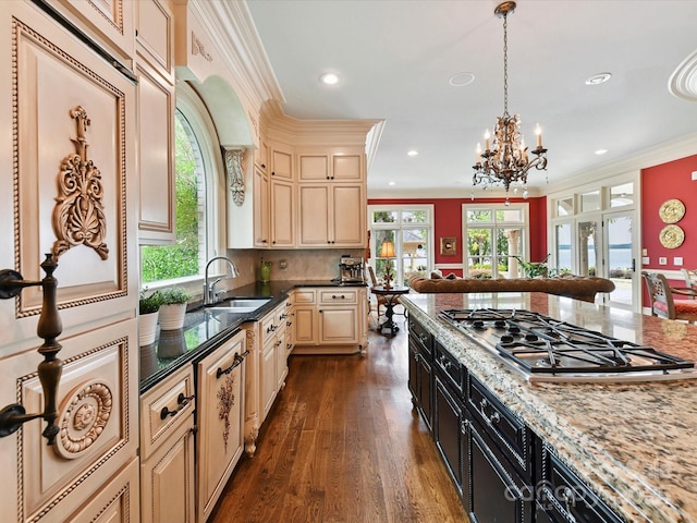 18201 Mainsail Pointe Dr, Cornelius, NC 28031 - kitchen with stainless steel gas stovetop, cream cabinetry, dark wood-style flooring, recessed lighting, and ornamental molding