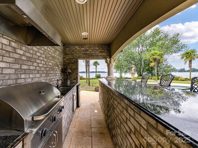 18201 Mainsail Pointe Dr, Cornelius, NC 28031 - view of patio featuring exterior kitchen and a water view