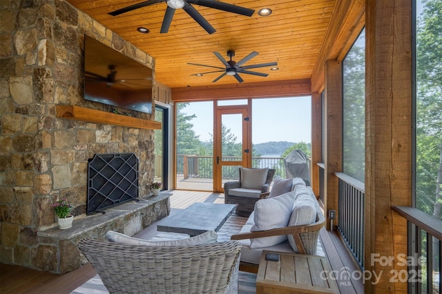 256 Hunt Camp Dr, Nebo, NC 28761 - sunroom featuring a ceiling fan, an outdoor living space with a fireplace, and plenty of natural light