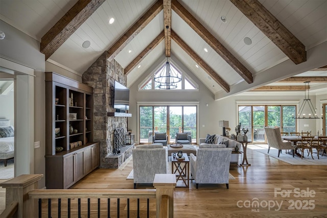 256 Hunt Camp Dr, Nebo, NC 28761 - living room with light wood finished floors, beamed ceiling, a fireplace, a chandelier, and high vaulted ceiling