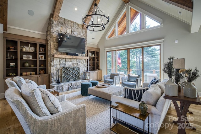 256 Hunt Camp Dr, Nebo, NC 28761 - living room featuring high vaulted ceiling, beam ceiling, a chandelier, wood finished floors, and a stone fireplace