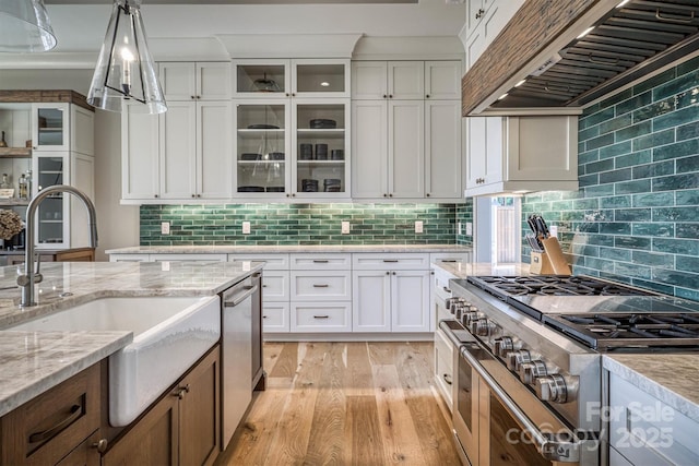 256 Hunt Camp Dr, Nebo, NC 28761 - kitchen featuring custom range hood, appliances with stainless steel finishes, light wood finished floors, white cabinets, and backsplash
