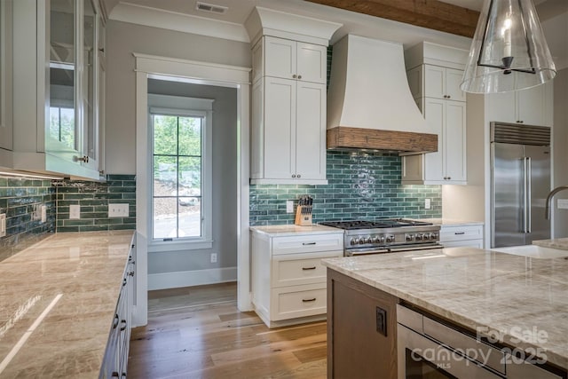 256 Hunt Camp Dr, Nebo, NC 28761 - kitchen featuring custom range hood, light wood-style flooring, light stone countertops, and tasteful backsplash