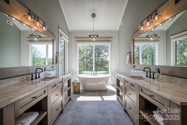 256 Hunt Camp Dr, Nebo, NC 28761 - bathroom featuring two vanities, a freestanding bath, crown molding, and stone finish flooring