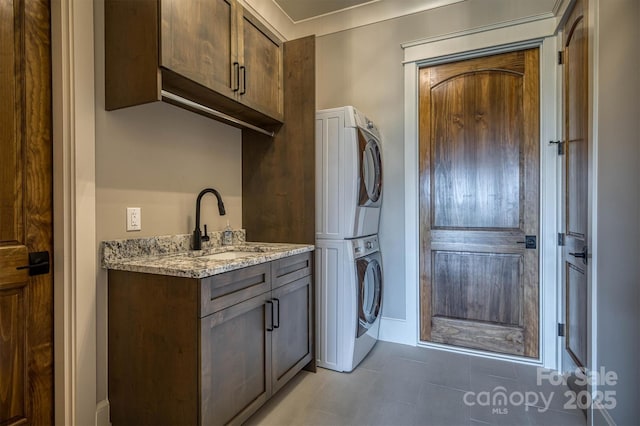 256 Hunt Camp Dr, Nebo, NC 28761 - washroom featuring stacked washer / dryer, cabinet space, and light tile patterned flooring
