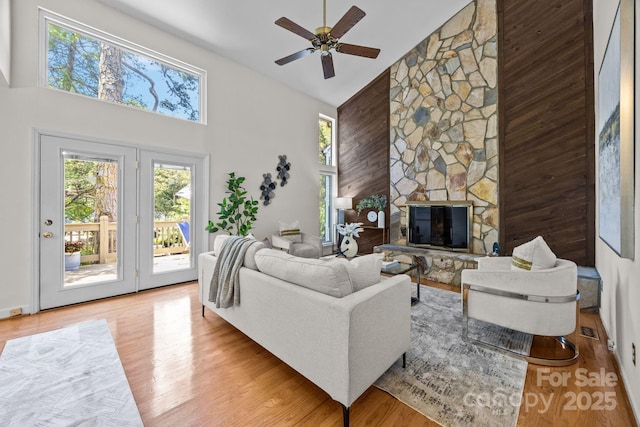 9008 St Croix Ln, Charlotte, NC 28277 - living room with high vaulted ceiling, a fireplace, ceiling fan, and wood finished floors