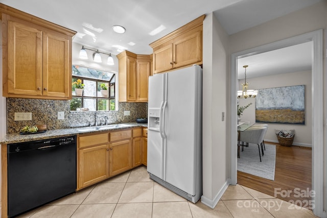 9008 St Croix Ln, Charlotte, NC 28277 - kitchen featuring white refrigerator with ice dispenser, dishwasher, light stone countertops, decorative backsplash, and a chandelier