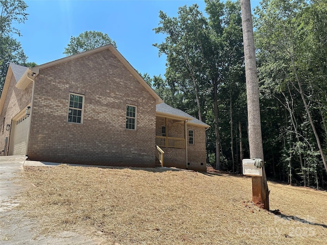 1031 Long Dr, Newton, NC 28658 - view of side of home featuring brick siding, an attached garage, concrete driveway, and crawl space