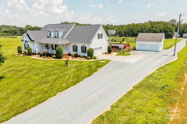 1123 Snyders Store Rd, Wingate, NC 28174 - cape cod home featuring a porch, an outbuilding, and a detached garage