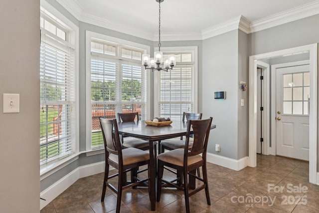1123 Snyders Store Rd, Wingate, NC 28174 - dining area featuring healthy amount of natural light, a chandelier, ornamental molding, and dark tile patterned floors