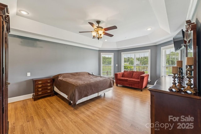 1123 Snyders Store Rd, Wingate, NC 28174 - bedroom featuring a tray ceiling, multiple windows, light wood finished floors, and recessed lighting