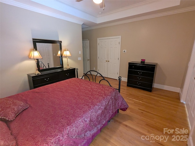 6301 Hawk Nest Dr, Concord, NC 28027 - bedroom with light wood-style flooring, a tray ceiling, crown molding, ceiling fan, and a closet