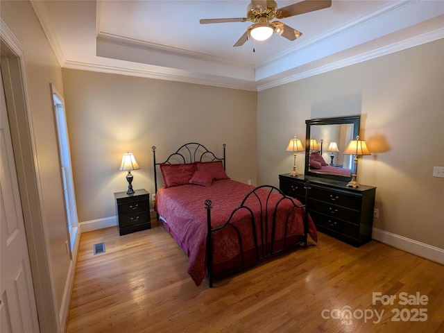 6301 Hawk Nest Dr, Concord, NC 28027 - bedroom featuring a raised ceiling, wood finished floors, ornamental molding, and ceiling fan