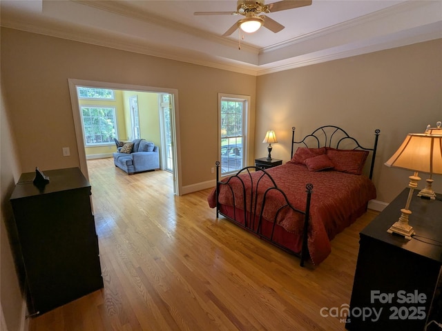 6301 Hawk Nest Dr, Concord, NC 28027 - bedroom with a tray ceiling, multiple windows, light wood-style floors, ornamental molding, and ceiling fan