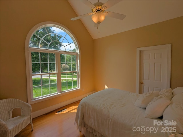 6301 Hawk Nest Dr, Concord, NC 28027 - bedroom featuring multiple windows, light wood-style floors, vaulted ceiling, and ceiling fan