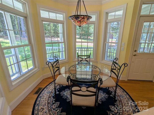6301 Hawk Nest Dr, Concord, NC 28027 - dining space featuring light wood finished floors and crown molding