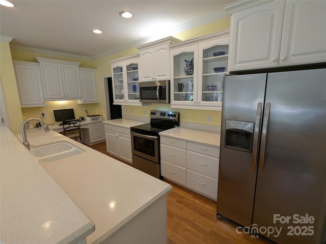 6301 Hawk Nest Dr, Concord, NC 28027 - kitchen featuring appliances with stainless steel finishes, crown molding, white cabinetry, glass insert cabinets, and recessed lighting