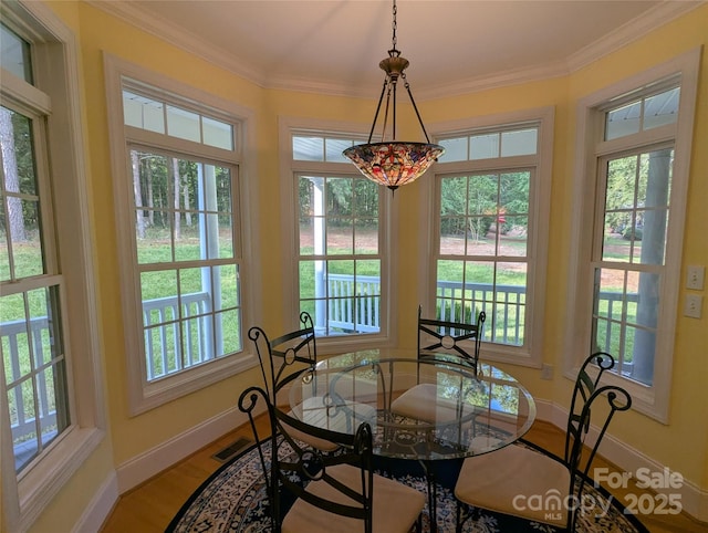 6301 Hawk Nest Dr, Concord, NC 28027 - dining room featuring plenty of natural light, ornamental molding, and light wood-style floors