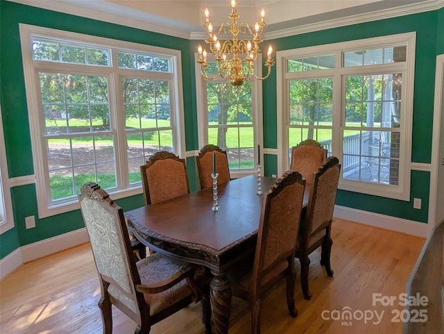 6301 Hawk Nest Dr, Concord, NC 28027 - dining room with crown molding, a chandelier, and light wood finished floors